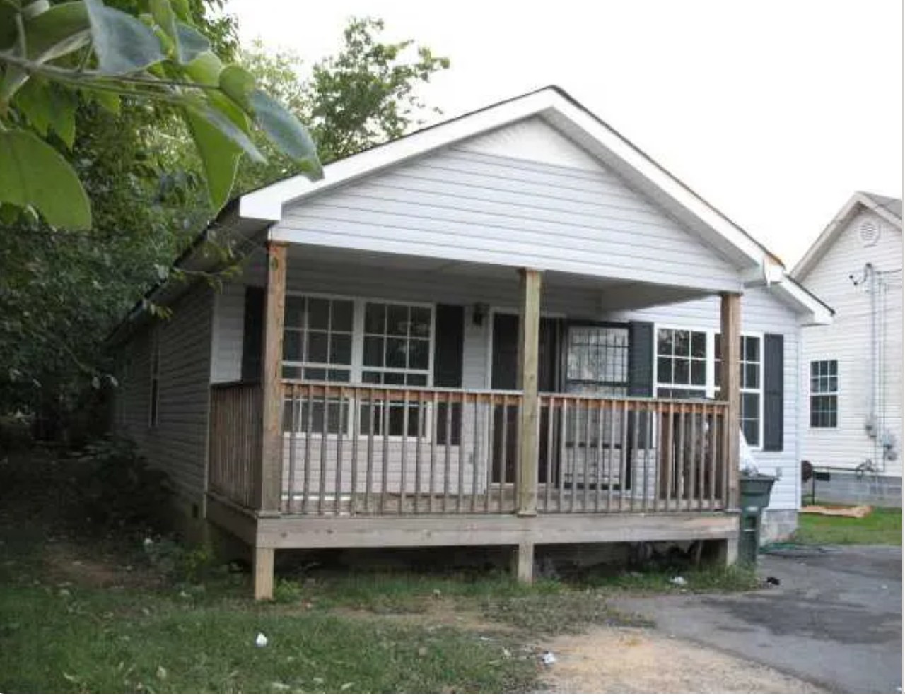 1630 S Greenwood Ave before — dated single family home with white siding and wood porch in Highland Park, Chattanooga