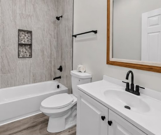 New bathroom with tile tub surround and framed mirror at 1713 S Orchard Knob Ave in Chattanooga