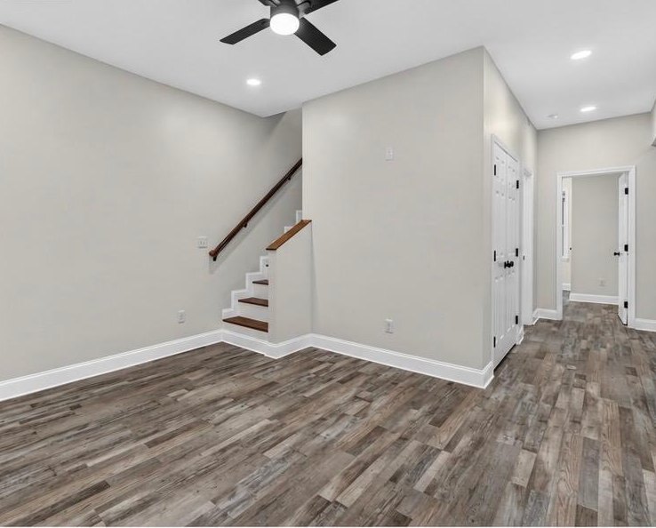 Renovated living room with staircase and new LVP flooring at 1713 S Orchard Knob Ave in Chattanooga