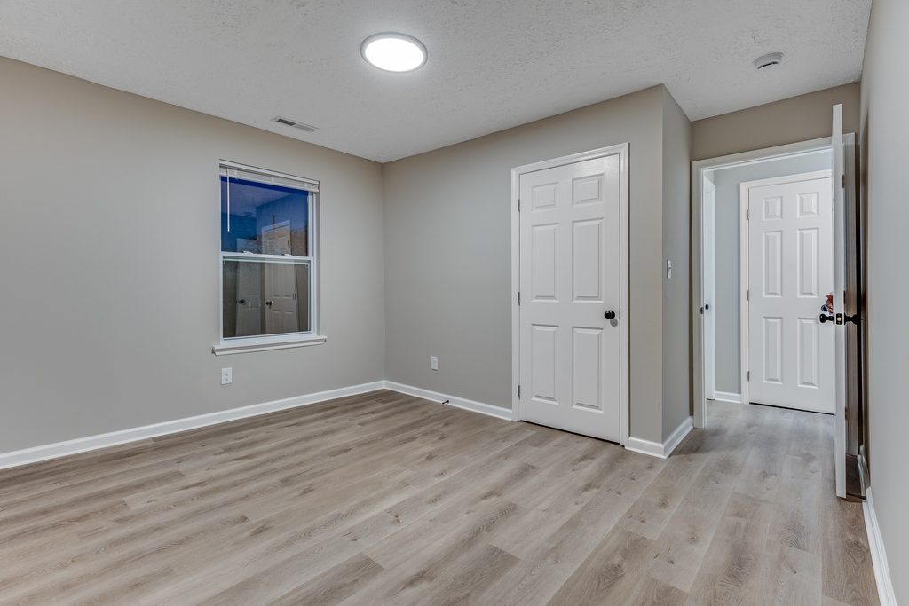 Renovated bedroom in Chattanooga — new interior doors, hardware, and wide-plank LVP flooring