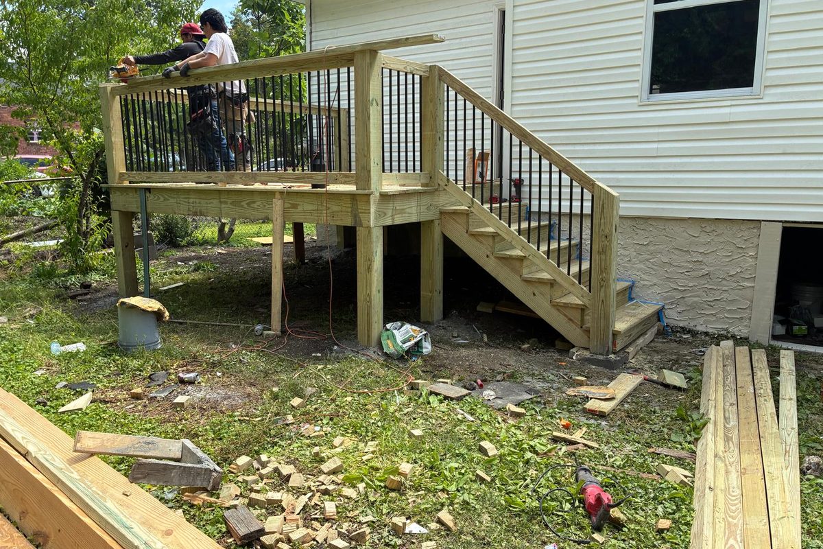 Custom-built rear deck and stairs in Chattanooga — pressure-treated framing with black metal balusters