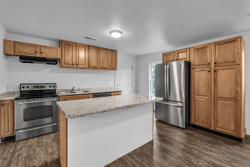 Renovated kitchen with island and granite counters at 2007 Wilson in Chattanooga